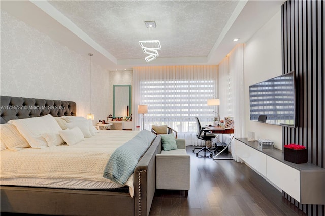 bedroom featuring dark wood-type flooring, a textured ceiling, and wallpapered walls