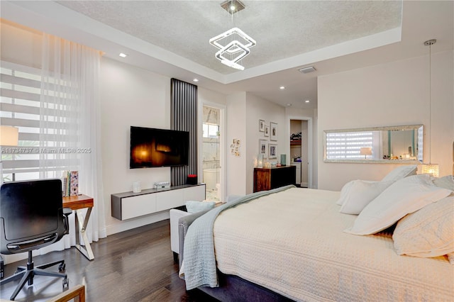 bedroom featuring visible vents, dark wood finished floors, a textured ceiling, and recessed lighting