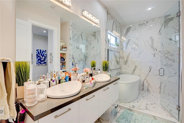 bathroom featuring double vanity, a freestanding bath, a marble finish shower, and a sink