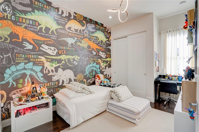 bedroom with recessed lighting, a closet, and wood finished floors