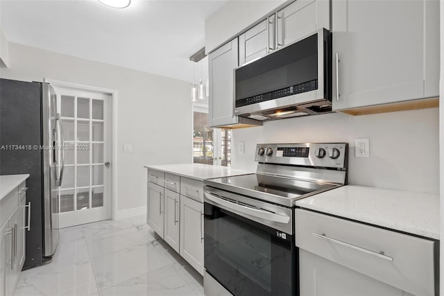 kitchen featuring appliances with stainless steel finishes and pendant lighting