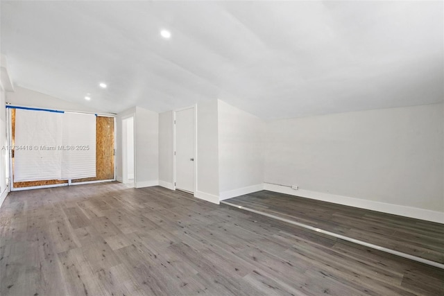 interior space featuring lofted ceiling and hardwood / wood-style floors