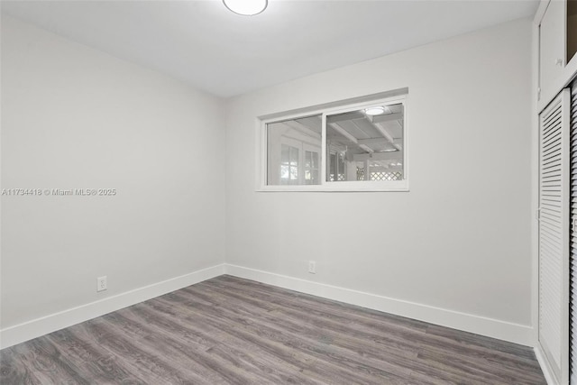 unfurnished bedroom featuring hardwood / wood-style flooring and a closet