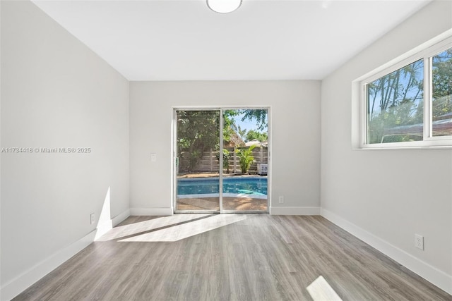 spare room with light hardwood / wood-style flooring