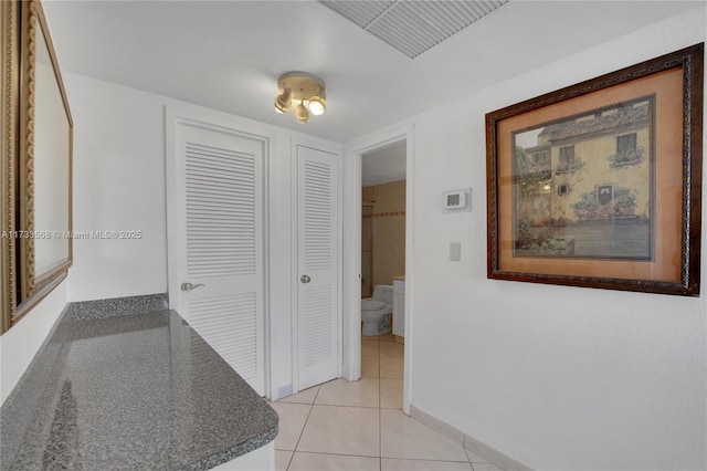 hallway with light tile patterned floors