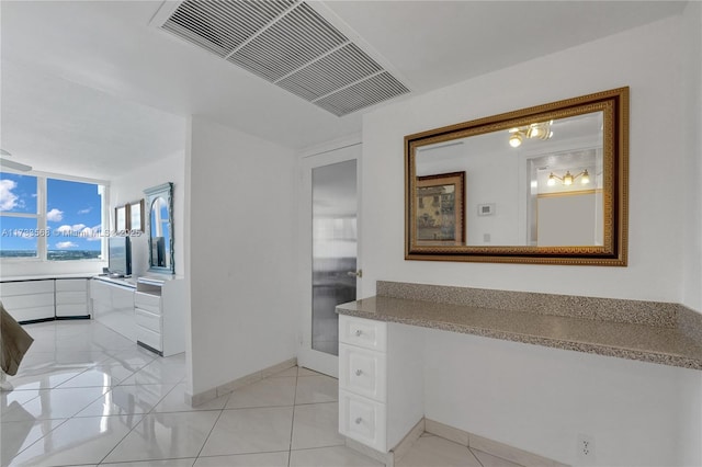 bathroom featuring tile patterned flooring and vanity