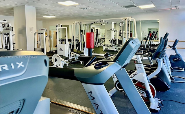 exercise room featuring a drop ceiling