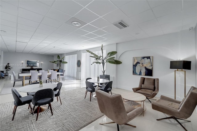 dining space featuring a drop ceiling