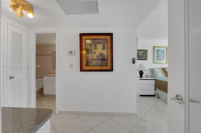 hall with light tile patterned floors