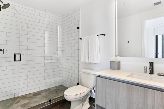 bathroom with vanity, toilet, and a shower with shower door