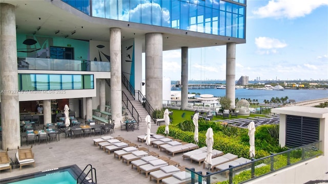 view of patio featuring a water view and a community pool