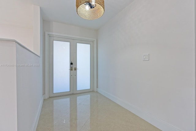 entrance foyer featuring light tile patterned floors and french doors