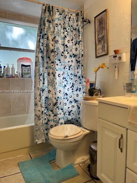 full bathroom with vanity, shower / tub combo, tile patterned floors, and toilet