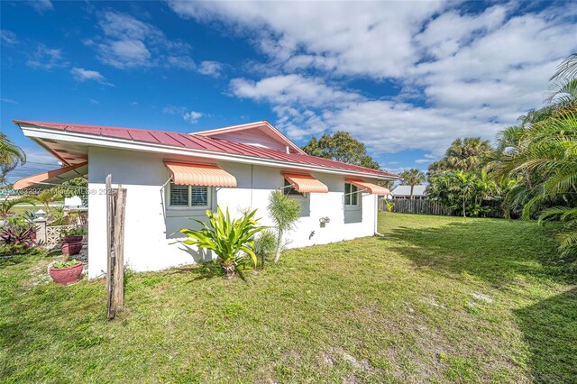 back of property featuring a lawn