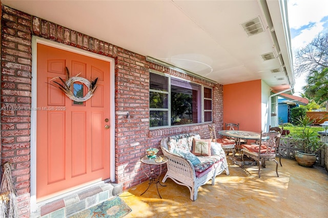 view of exterior entry with covered porch