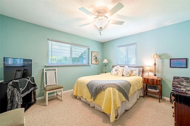 carpeted bedroom with multiple windows, ceiling fan, and a textured ceiling