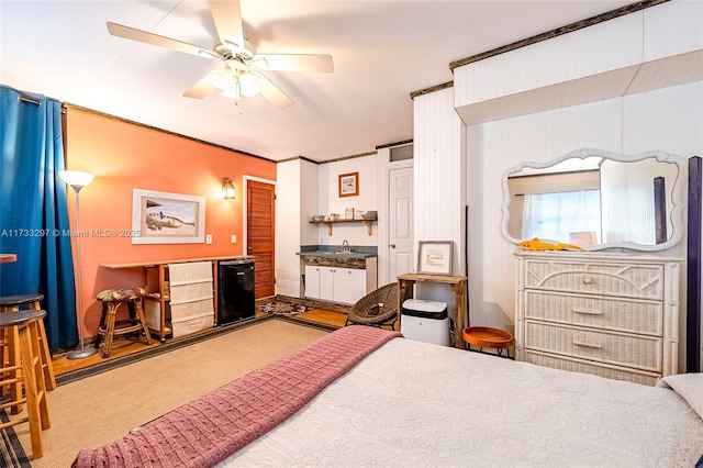 carpeted bedroom featuring sink, ceiling fan, and refrigerator