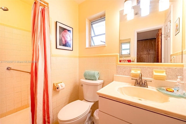 bathroom featuring vanity, toilet, tile walls, and a shower with shower curtain