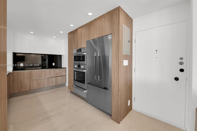 kitchen with tasteful backsplash, stainless steel appliances, and white cabinets