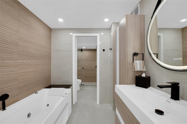 full bathroom with tile walls, vanity, independent shower and bath, and toilet