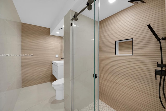 bathroom with tile patterned floors, toilet, an enclosed shower, tile walls, and vanity