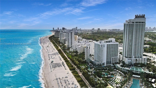 bird's eye view featuring a view of the beach and a water view