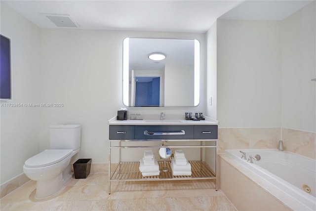 bathroom with tile patterned flooring, vanity, a bathing tub, and toilet