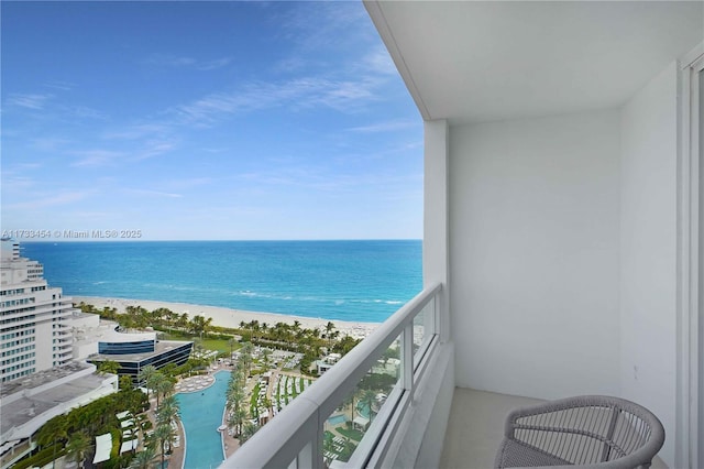 balcony with a water view and a beach view