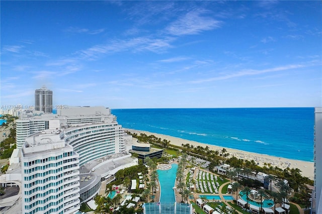 drone / aerial view featuring a beach view and a water view