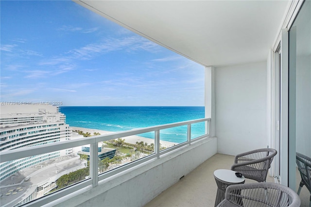 balcony with a beach view and a water view