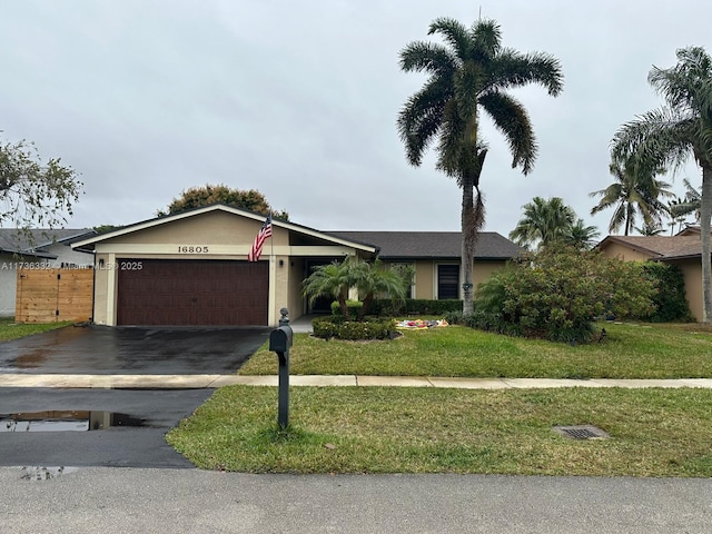 ranch-style home with a garage and a front lawn