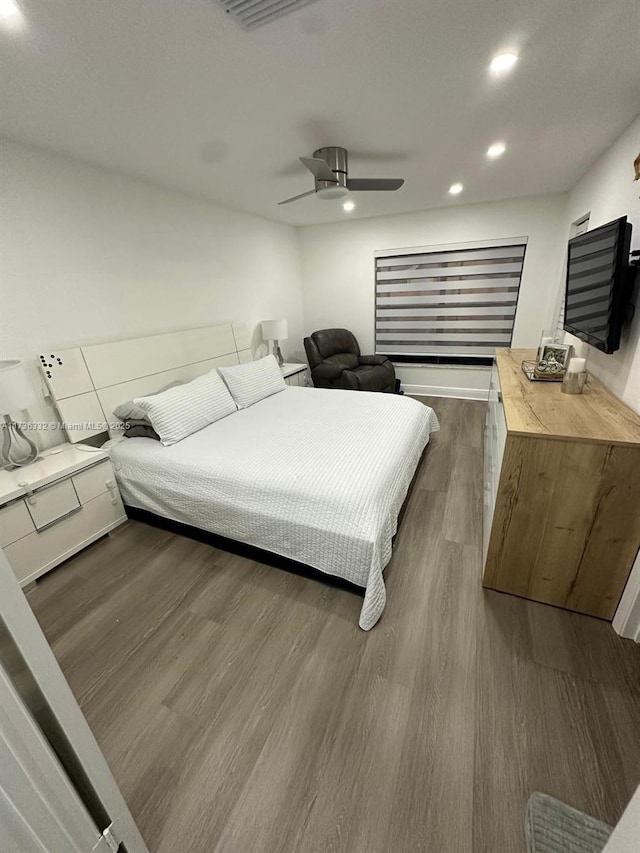 bedroom featuring dark hardwood / wood-style flooring and ceiling fan