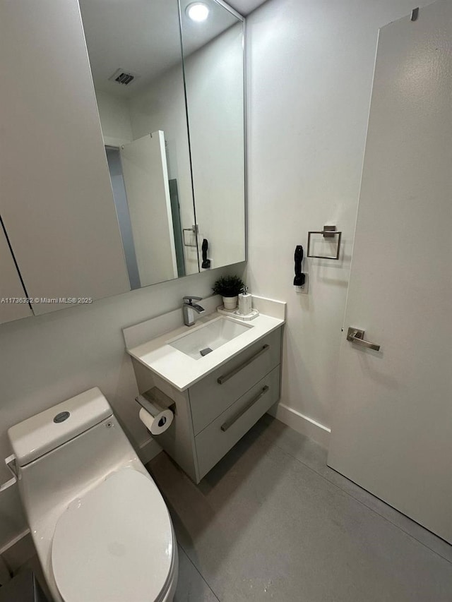 bathroom featuring vanity and toilet