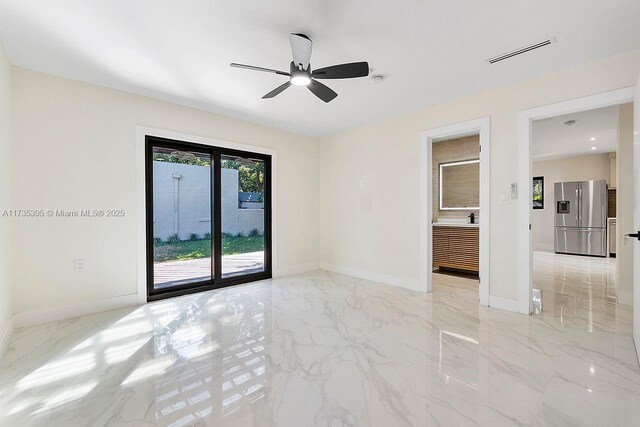 1816 SW 11th Ter, Miami, FL 33135 - empty room featuring baseboards, a ceiling fan, and light marble finish floors