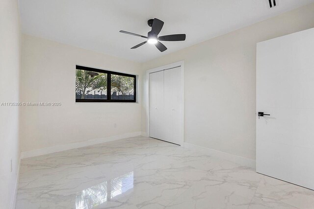 1816 SW 11th Ter, Miami, FL 33135 - unfurnished bedroom with a closet, baseboards, marble finish floors, and ceiling fan