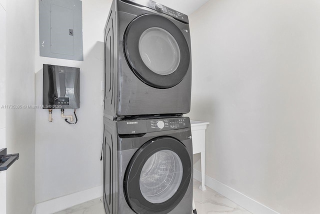 1816 SW 11th Ter, Miami, FL 33135 - laundry area with electric panel, stacked washer and clothes dryer, light marble finish floors, and baseboards