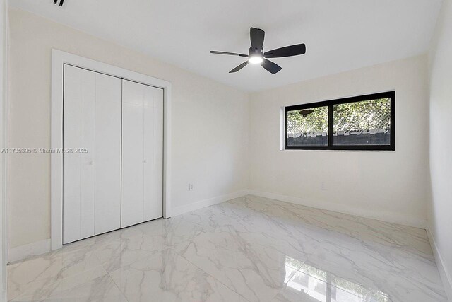 1816 SW 11th Ter, Miami, FL 33135 - unfurnished bedroom with marble finish floors, a closet, baseboards, and ceiling fan