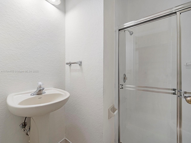 bathroom featuring an enclosed shower