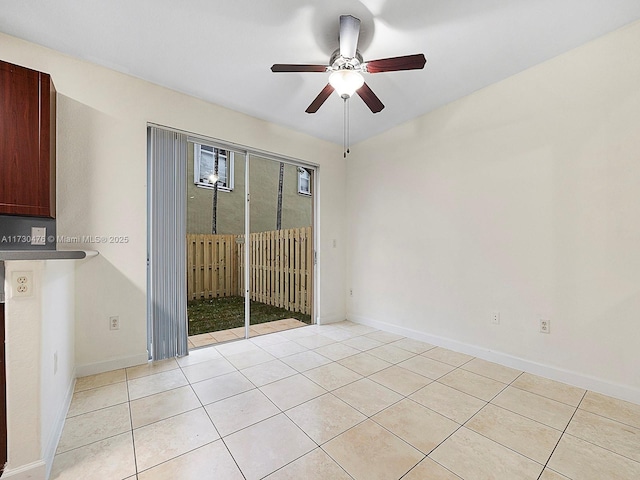 tiled empty room featuring ceiling fan