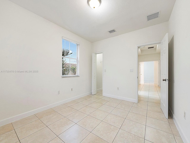 empty room with light tile patterned flooring