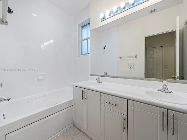 bathroom featuring tile patterned flooring, vanity, and a washtub