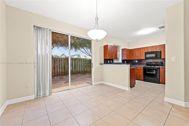 kitchen with pendant lighting, decorative backsplash, light tile patterned floors, and black appliances