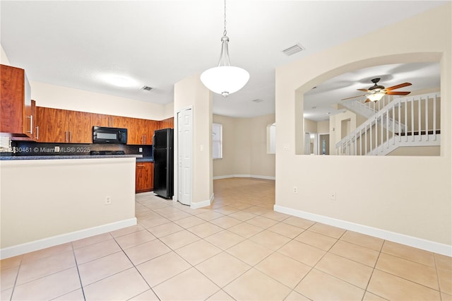 kitchen featuring light tile patterned flooring, tasteful backsplash, hanging light fixtures, ceiling fan, and black appliances