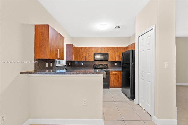 kitchen featuring kitchen peninsula, decorative backsplash, light tile patterned floors, and black appliances