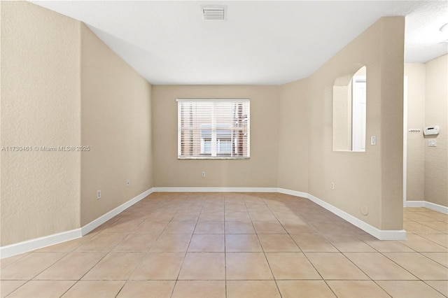 empty room with light tile patterned floors