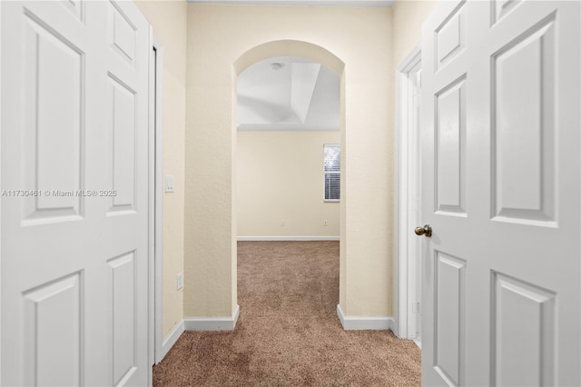 corridor featuring light colored carpet