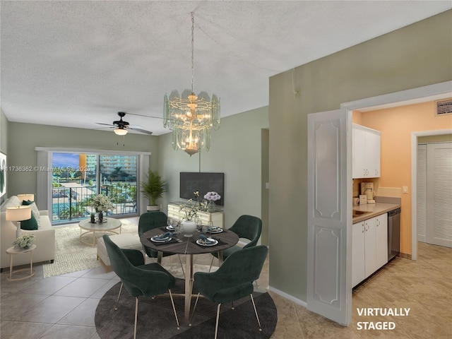 tiled dining room with a textured ceiling and a chandelier