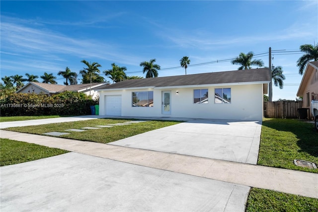 single story home with a garage and a front yard