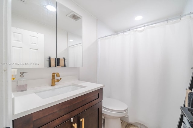 bathroom featuring vanity and toilet