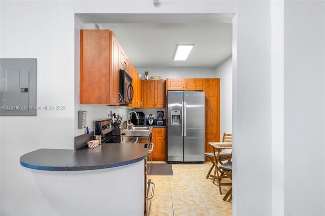 kitchen featuring sink, stainless steel appliances, electric panel, and light tile patterned flooring